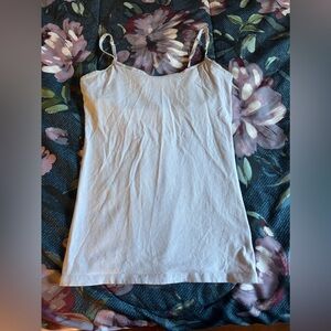 SO small white tank top with built in bra. Used but in good condition.